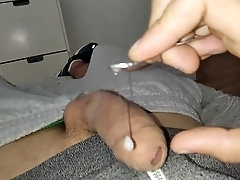 Horny guy plays with a spoon inside his throbbing cock until he explodes with cum