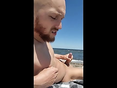 'Brainwashed gooner boy strokes his cock on public beach'