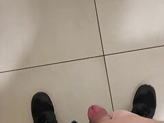 boy is wanking in mall stall bathroom